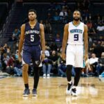 Nov 21, 2016; Charlotte, NC, USA; Memphis Grizzlies guard Andrew Harrison (5) and his brother Charlotte Hornets guard Aaron Harrison (9) walk down the court together late in the second half at Spectrum Center. Memphis defeated Charlotte 105-90. Mandatory Credit: Jeremy Brevard-USA TODAY Sports