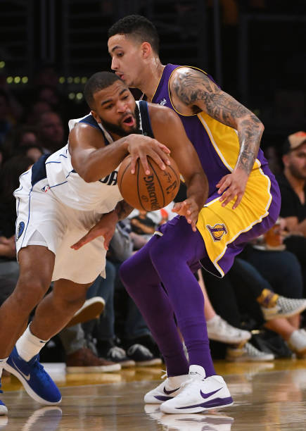 LOS ANGELES, CA - MARCH 28:  Kyle Kuzma #0 of the Los Angeles Lakers and Aaron Harrison #9 of the Dallas Mavericks battle for the ball in the game at Staples Center on March 28, 2018 in Los Angeles, California.  (Photo by Jayne Kamin-Oncea/Getty Images)  NOTE TO USER: User expressly acknowledges and agrees that, by downloading and or using this photograph, User is consenting to the terms and conditions of the Getty Images License Agreement.